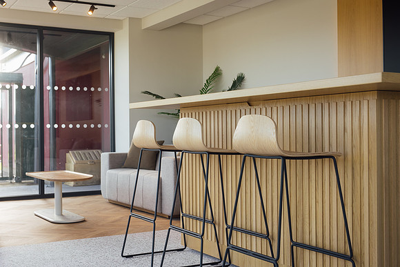 Wooden stools as part of a commercial reception space