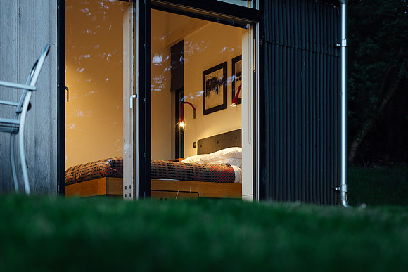 Looking through the windows into the bedroom of a Canopy & Stars space