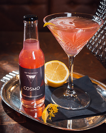 On The Rocks cosmopolitan cocktail in a glass with orange