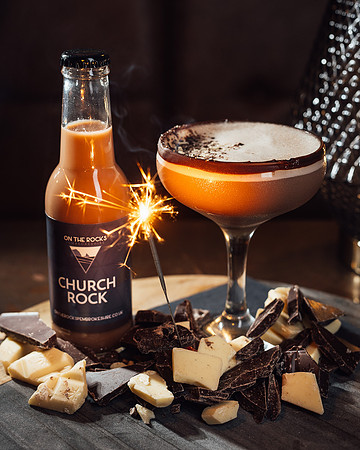 On The Rocks Church Rock cocktail in a glass with chocolate pieces