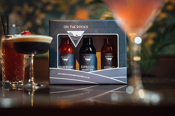 Cocktails with On The Rocks packaging in the background