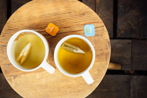 Two cups of fruit tea from above on a side table