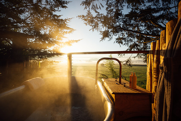 A steaming hot bath captured at sunrise at Orchard at Fenny