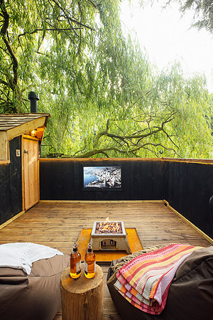 Incredible roof top terrace with television and overhanging willow tree