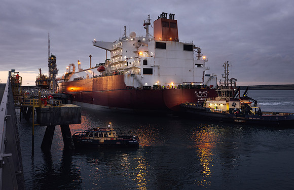LNG tanker is positioned by TUGs