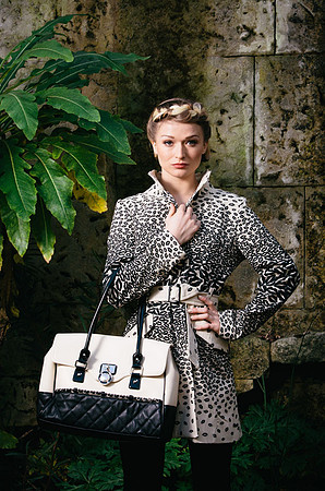 Female model during fashion photoshoot carrying white bag