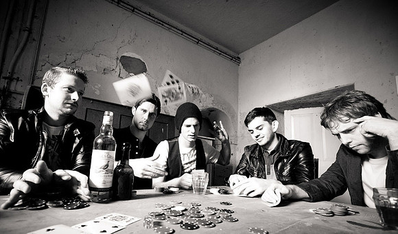 Band photography showing group playing cards