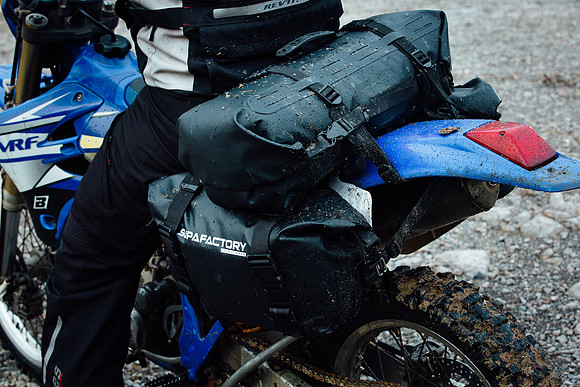 Dirty superfactory products on the back of an offroad motorcycle
