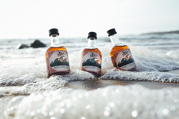 Three barti mini bottles washed up on the shore