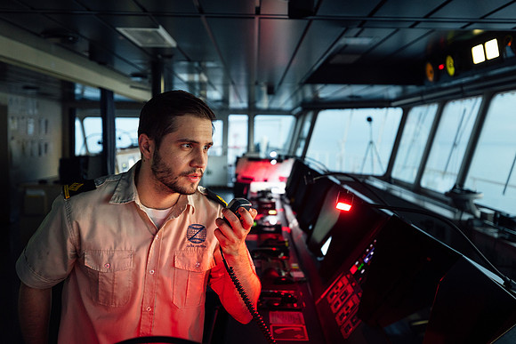 Crew member communicating at the bridge of a containership