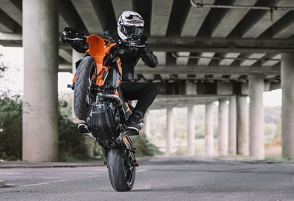Stunt ride pops a wheelie on a KTM 690 SM