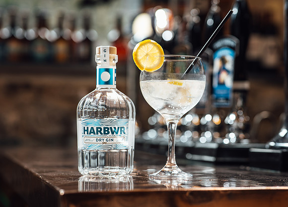 Harbwr gin with bottle and glass resting on a bar