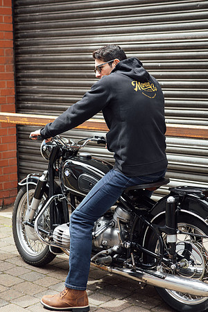 Male model stiting on a BMW R60 motorcycle