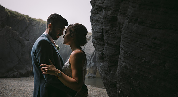 Bride and Groom get cosy together in a misty cove near Gwbert - Wedding Photography in Pembrokeshire