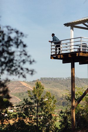 A man looks out towards the views from the balcony at Paraiso Escondido