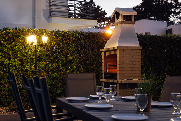 Outdoor barbeque and pizza over at dusk