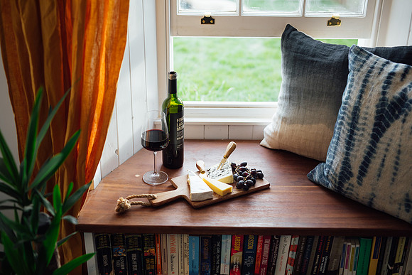 Cheese and wine board by an open window