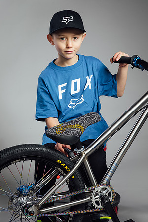 Very young BMX rider posing in the studio